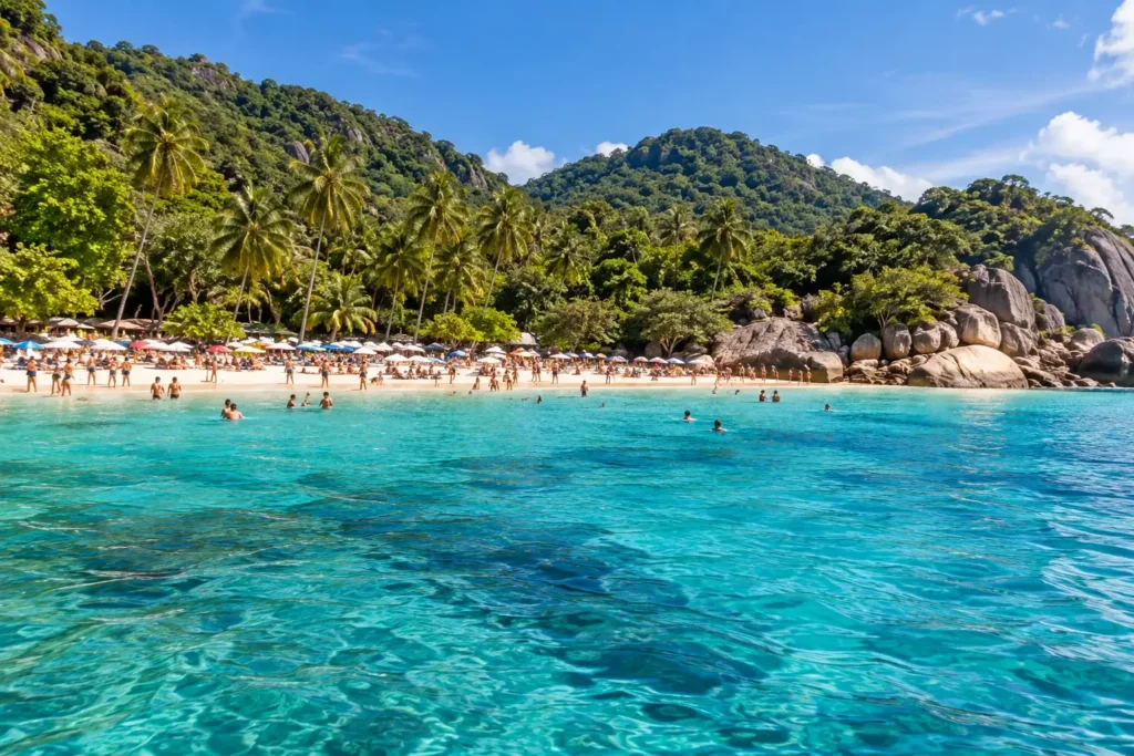 A busy beach scene seen from offshore for Phuket high season planning — AI-generated illustration